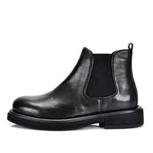 Side profile view showing the soft black leather and elastic panel of the Chelsea boot