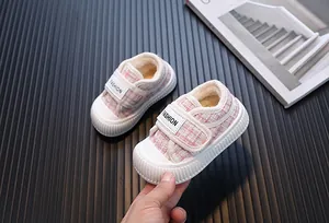 Dettaglio di scarpe in tweed rosa per bambine con fodera in peluche e chiusura a strappo