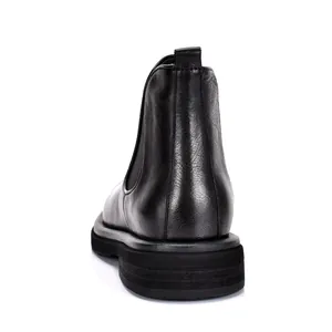 Rear view detail of black genuine leather Chelsea boot with thick platform sole for men