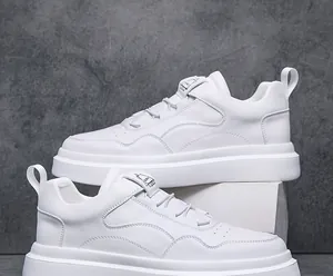 Side detail of white men's low-top slip-on sneakers with minimalist design and thick soles