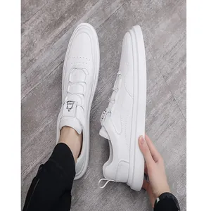 Close-up detail of white men's slip-on sneakers with a minimalist low-top design