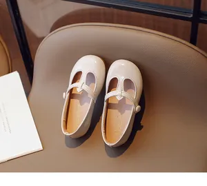 Close-up detail of beige cream Mary Jane leather flats for toddler girls with T-strap