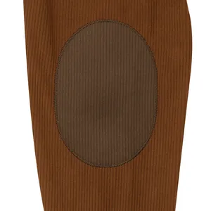 Detailed macro view of brown corduroy fabric and contrast oval patch on men's sweatshirt