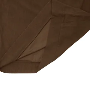 Detail macro view showing the brown corduroy fabric texture and hem of the sweatshirt.