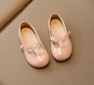 Detailed view of pink T-strap toddler Mary Janes with round toe and button detail