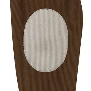 Close-up of contrast grey oval patch on brown corduroy sleeve of men's sweatshirt