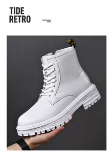 Detail of white leather Martin boots featuring a thick sole and lace-up design