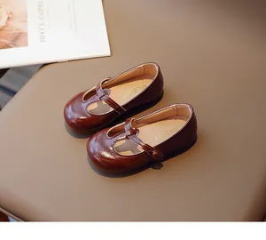 Detailed view of glossy brown T-strap Mary Jane shoes for toddler girls with MG BABY insole.