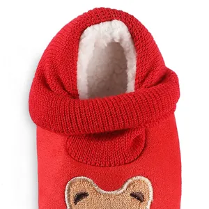 Close-up of red baby shoes showing thick fleece lining and cartoon bear embroidery