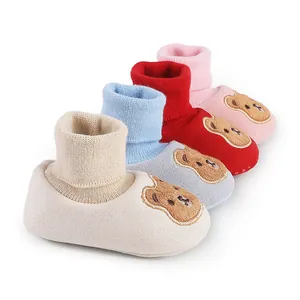 Four pairs of soft sole cartoon bear baby shoes in beige blue red and pink colors
