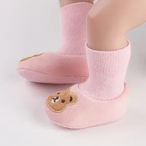Detailed view of pink baby socks shoes with cartoon bear embroidery and anti-slip sole