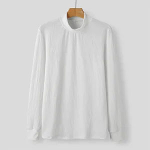 Detail of men's white mock neck shirt featuring textured water ripple fabric pattern.