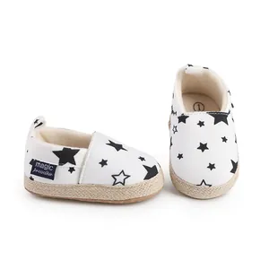 Primer plano de zapatos de lona blanca para bebés con bonitos estampados de estrellas