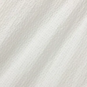 Close-up detail showing the unique water ripple texture of white knit fabric.