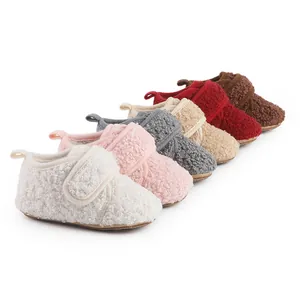 Close-up of plush baby winter walking shoes in various colors with soft wool-like textures