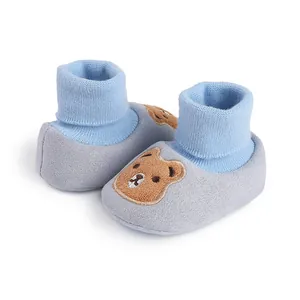 Soft sole baby booties with cute bear embroidery and blue ribbed cuffs for infants