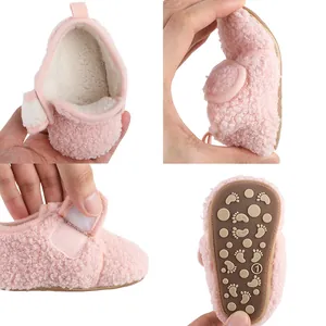 Detailed views of pink fleece baby shoes showing soft sole flexibility and anti-slip grip
