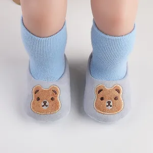 Macro view of baby indoor soft sole shoes with a cute cartoon bear embroidery design