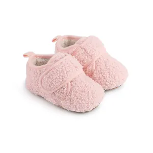 Detailed view of pink fuzzy winter baby walker shoes with soft sherpa texture
