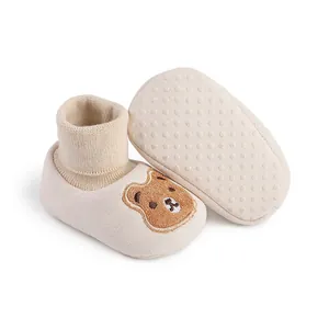 Detail view of cartoon bear baby indoor shoes showing soft knit and anti-slip sole.