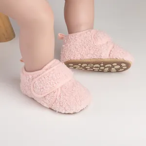 Close-up detail of soft pink sherpa baby walking shoes with non-slip soles for winter warmth