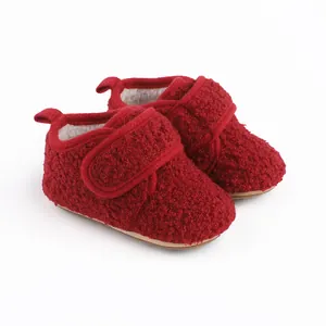 Close-up detail of red sherpa baby walker shoes with warm white fleece lining for winter