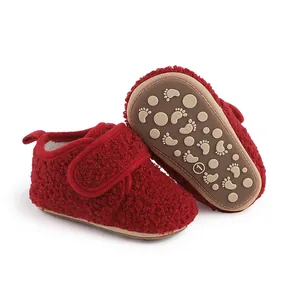 Detailed view of red plush baby walking shoes with anti-slip sole and Velcro strap