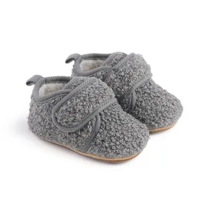 Detailed view of grey curly fleece baby winter walking shoes with soft warm lining.