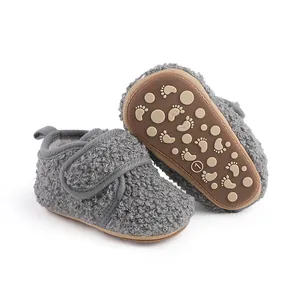 Detailed view of grey baby fleece walker shoes featuring non-slip footprint patterned soles