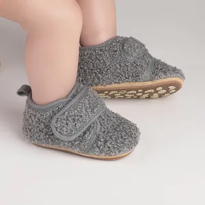 Close-up detail of grey sherpa fleece baby walking boots with non-slip patterned soles