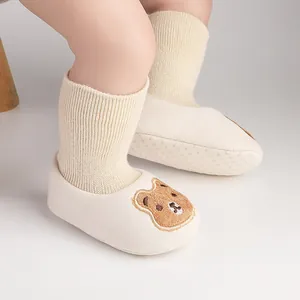 Warm fleece-lined baby pre-walker shoes with cute bear embroidery for winter season.