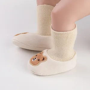 Cute fleece-lined baby walker shoes with bear embroidery on baby's feet
