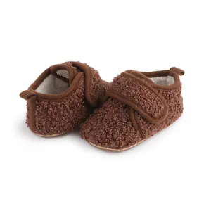 Detailed macro view of brown plush baby winter shoes featuring soft warm sherpa lining