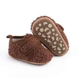 Close-up of cozy brown fleece baby walking shoes with anti-slip soles and velcro strap