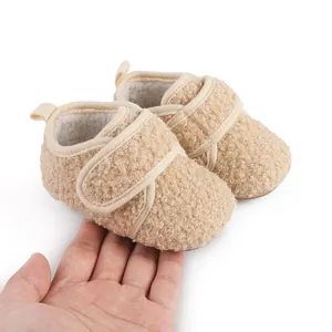 Detail view of cozy beige fleece baby winter shoes with soft velcro straps for warmth