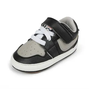 Close-up view of black and grey stylish baby walking shoes with white laces for infants