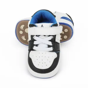 Front view and anti-slip sole detail of white and black baby walking shoes
