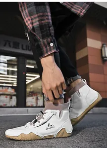 Close-up of white men's high-top sock boots featuring a unique octopus rubber sole
