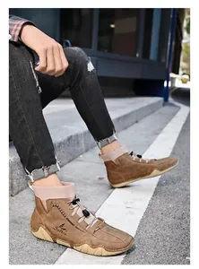 Detailed side view of brown men's mid-top casual sock boots with thick octopus rubber sole
