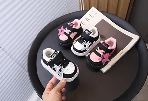 Close-up of warm children sneakers with star charms and soft faux fur lining
