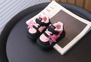 Macro view of pink and black toddler sneakers with cozy fuzzy lining and star charms