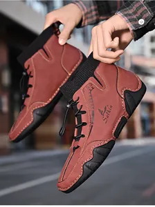 Detailed view of reddish-brown men's casual sock boots with unique octopus-patterned soles.