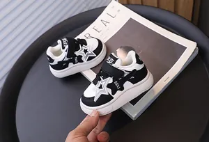 Detailed side view of children's warm winter sneakers with plush lining and star design