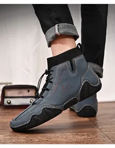 Close-up detail of blue men's mid-top sock sneakers featuring a durable octopus rubber sole