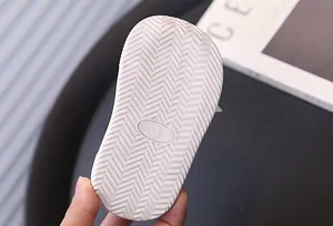 Detailed macro view of non-slip chevron pattern outsole on children warm sneaker