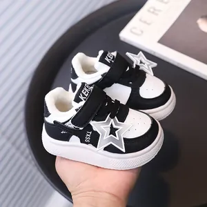 Classic black and white toddler winter sneakers featuring star detail and cozy plush lining