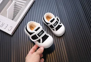 Close-up of warm fur-lined black canvas sneakers for toddlers featuring adjustable Velcro straps