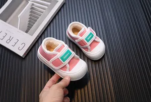 Detail shot of pink fleece-lined children canvas shoes with velcro strap closure