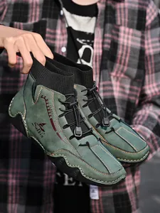 Green high-top casual men's boots with sock collar and unique octopus sole design