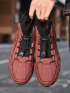 Men's casual mid-cut sock boots in reddish-brown leather with elastic laces and knit collar.